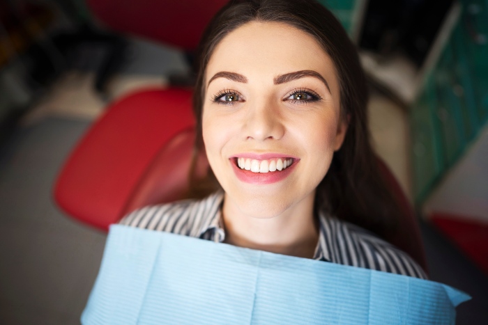 Young lady in the middle of a dental deep cleaning procedure in Kalamazoo, MI